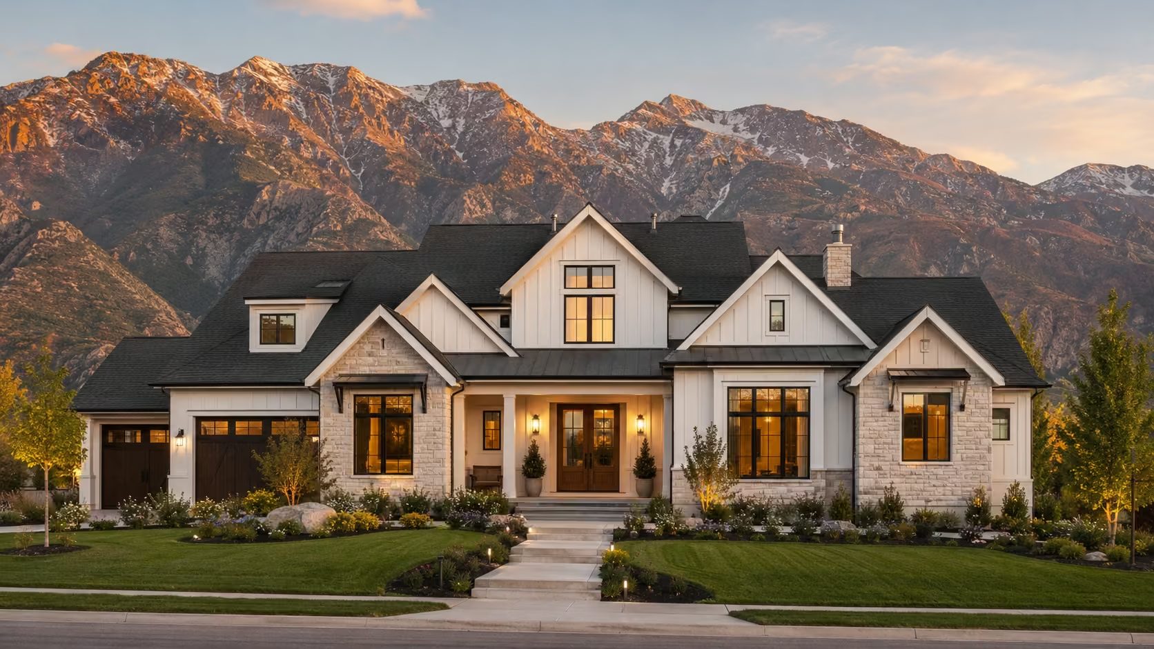 A well-kept modern farmhouse-style home glowing at golden hour beneath the Wasatch mountains